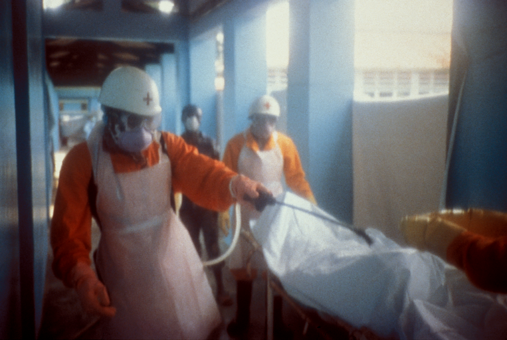 Health workers in protective suits attending to a patient at an Ebola treatment facility in the Democratic Republic of Congo.