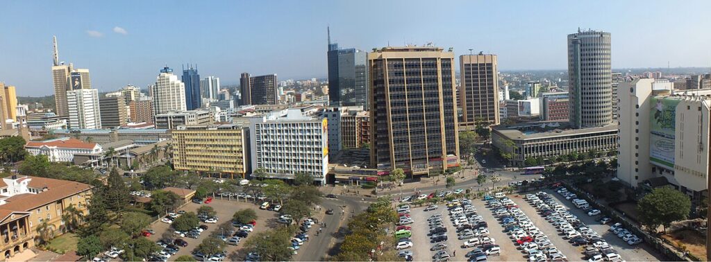 Wide exterior view of a large modern courthouse in an African capital during daytime, with steps and a public square in front.