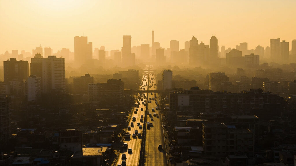 A panoramic view of a dense African megacity skyline at golden hour, with high-rise buildings stretching to the horizon.