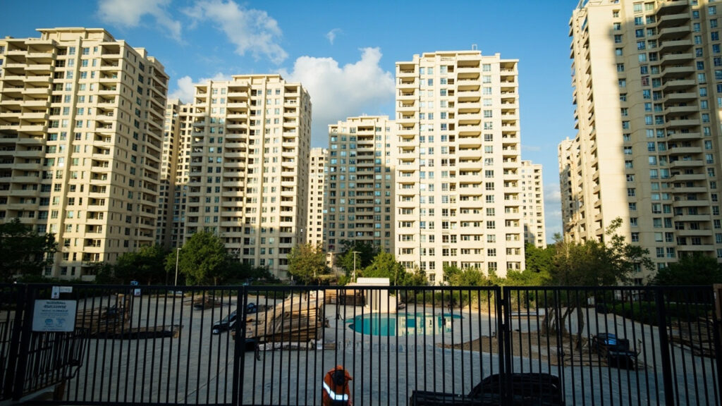 A modern mid-rise residential apartment development with landscaped grounds, parking and shared amenities in an urban Kenyan setting.