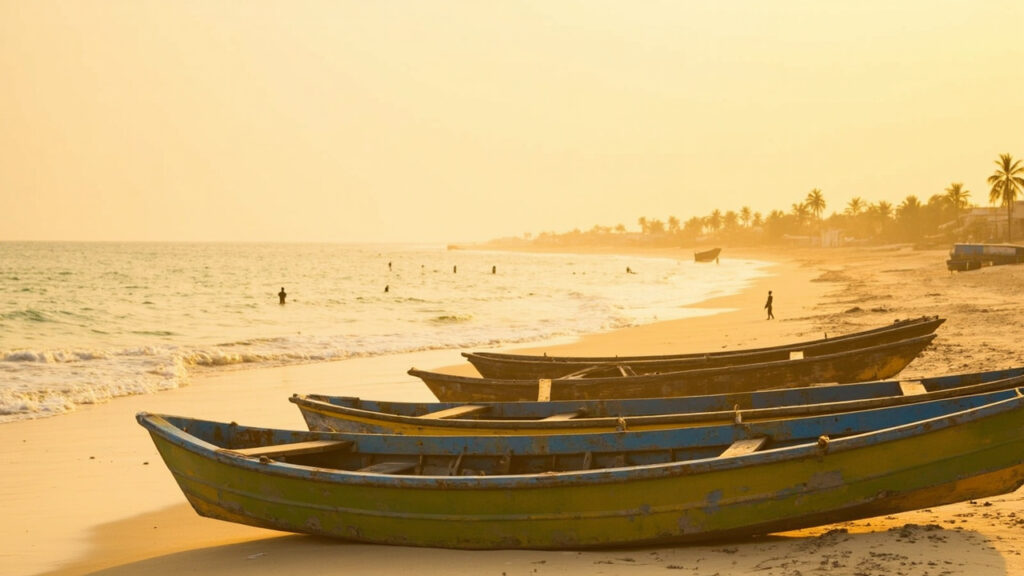 A sandy West African Atlantic coastline at golden hour with fishing boats on the shore.