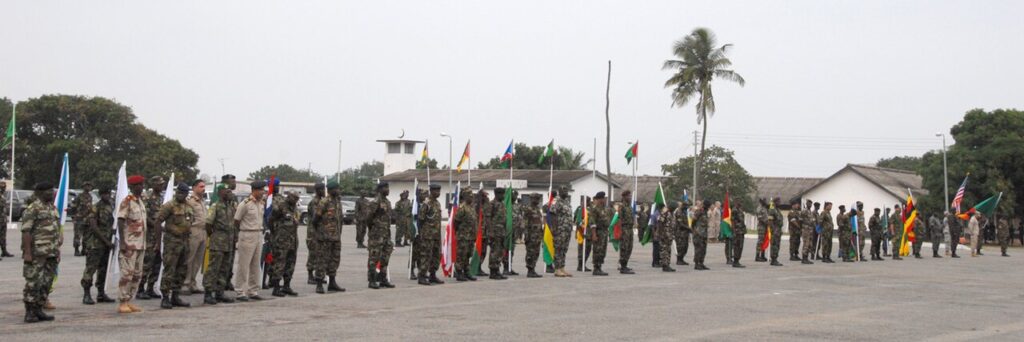 Nigerian Army soldiers in camouflage uniforms standing in formation on a parade ground during a military ceremony.