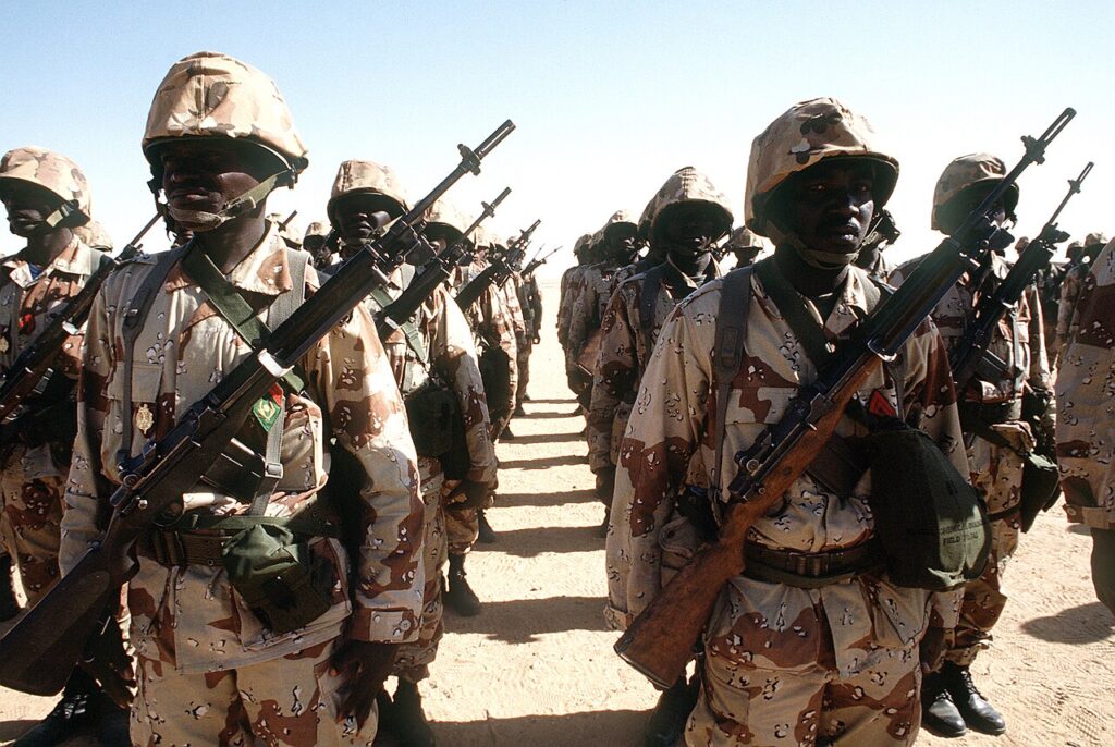Nigerian army soldiers in camouflage uniforms standing in formation on a parade ground during a military assembly.