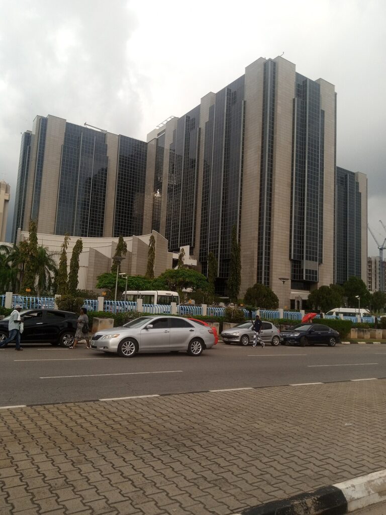 An exterior view of Nigeria's Central Bank building in Abuja, showing its modern government architecture under a clear sky.