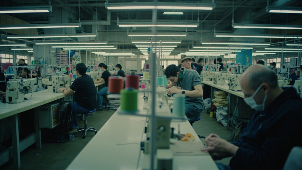 Workers inside a South African garment factory operating industrial sewing machines.