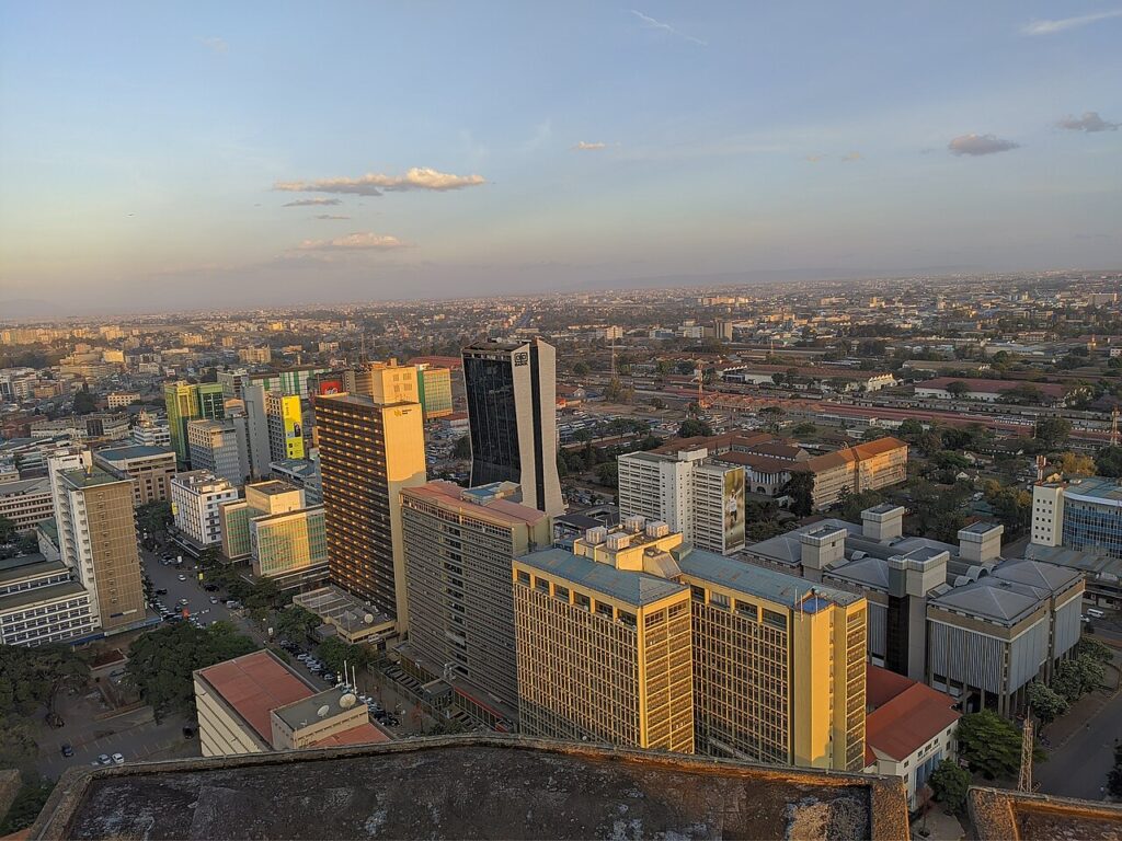 A modern African city commercial street with pedestrians and office workers, illustrating contemporary urban work life.